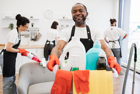 man-holding-detergents-cleaning-home